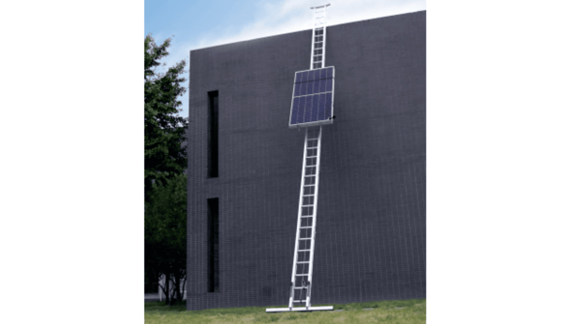 A tall ladder with a mounted solar panel leans against a modern dark gray building, reaching toward the roof, with grass in the foreground and a tree partially visible on the left.