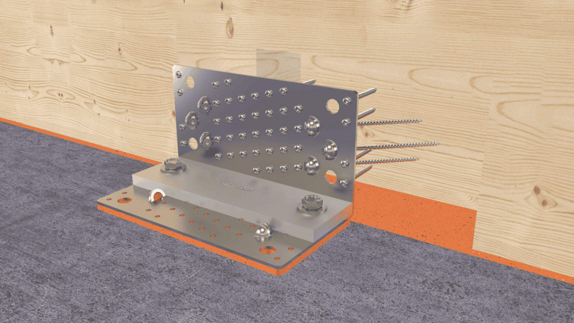 A metal bracket connector attached to a wooden wall with large screws, secured to a concrete floor with bolts, shown in a construction setting.