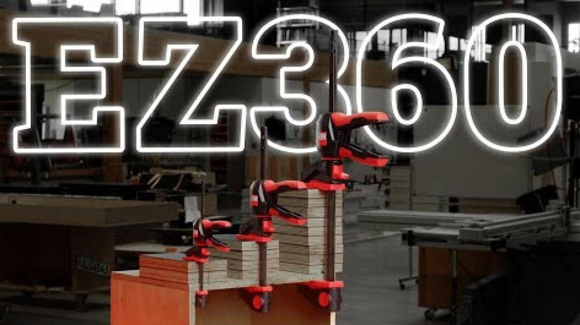 A stack of wooden boards clamped together with red and black clamps in a workshop. The large translucent text EZ360 is displayed across the image.