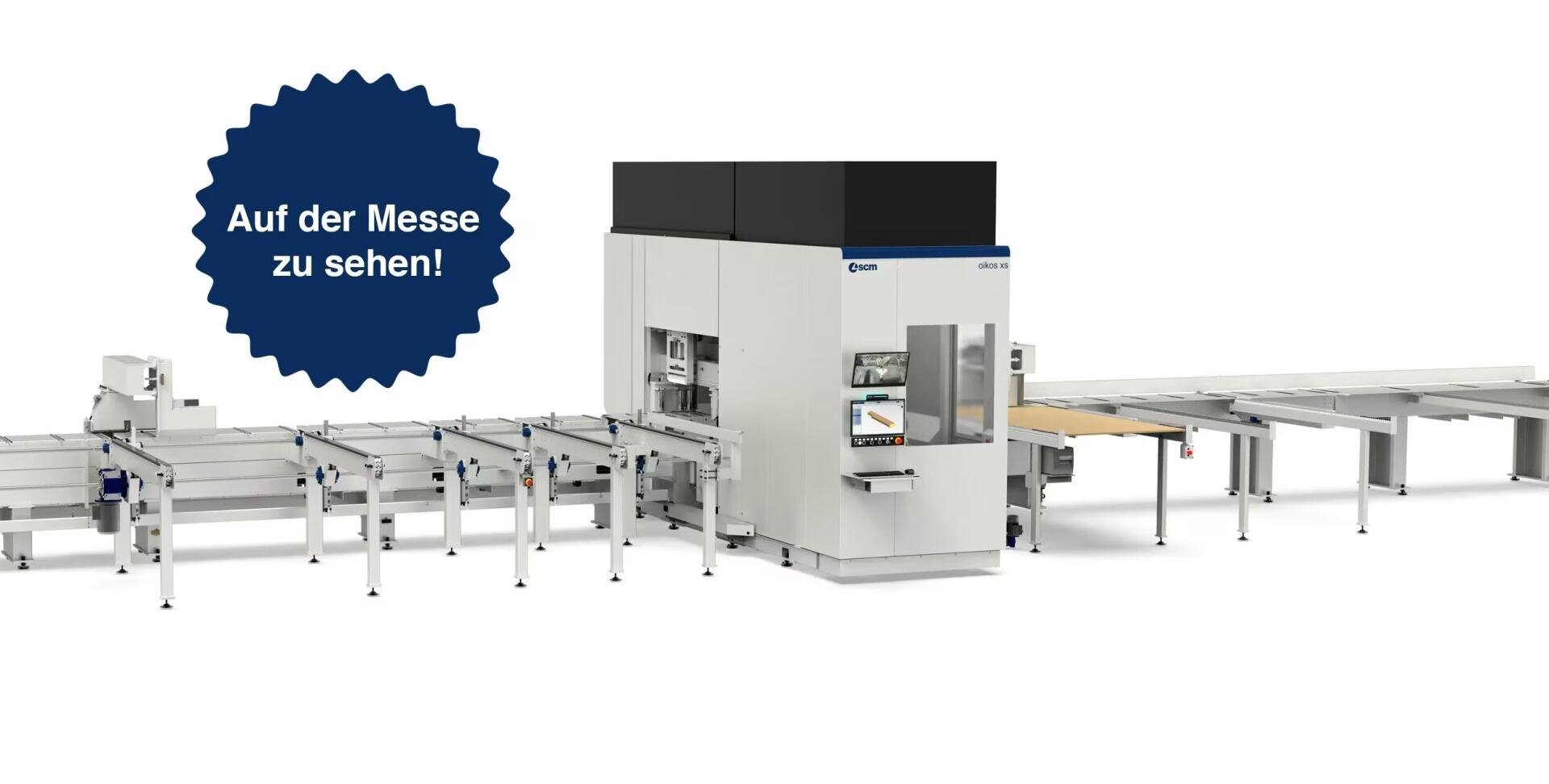 Industrial machine with conveyor belts, shown against a white studio background. A blue starburst graphic on the left says "Auf der Messe zu sehen!" (To be seen at the fair!) in German.