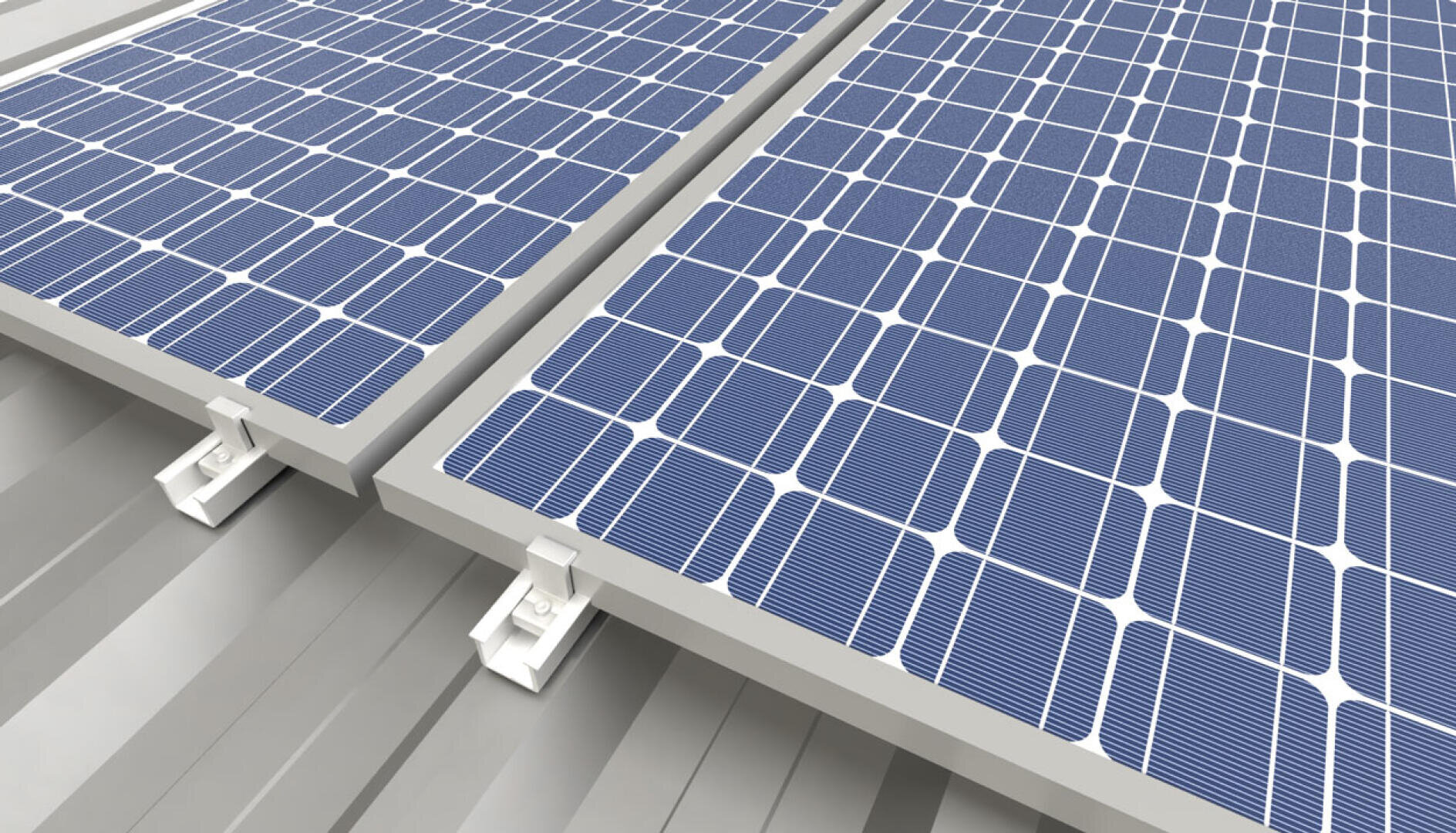 Close-up view of blue solar panels installed on a grey metal roof, showing the panel mounting brackets and the texture of the roof surface.