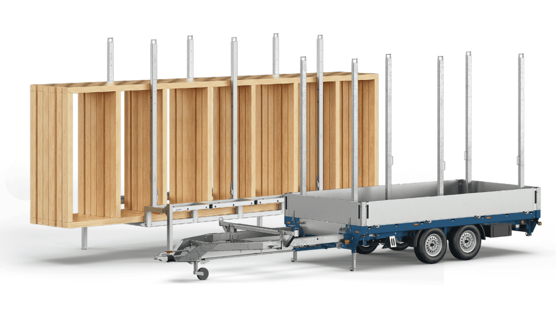 A flatbed trailer with metal posts is parked next to a large wooden frame structure, likely used for transporting or supporting building materials.