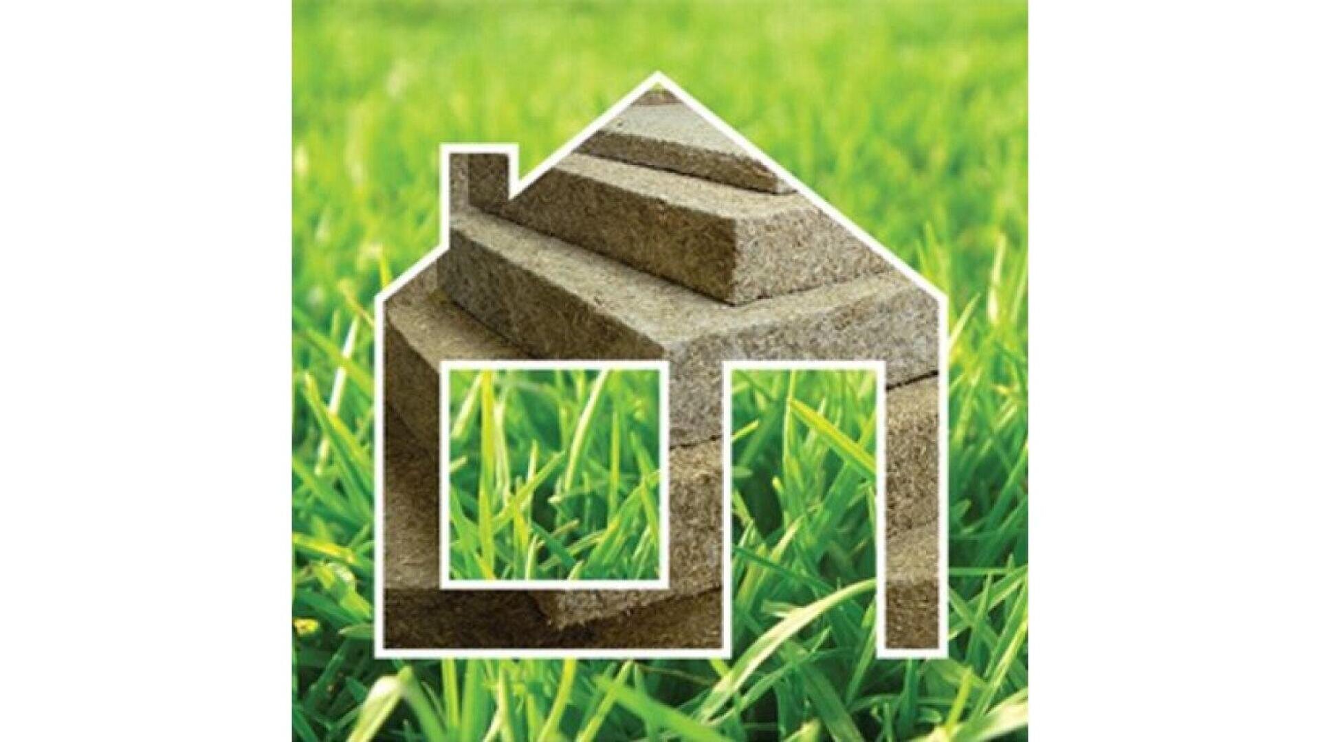 A white outline of a house is overlaid on green grass, with several stacked pieces of sod inside the outline, symbolizing landscaping or lawn installation.